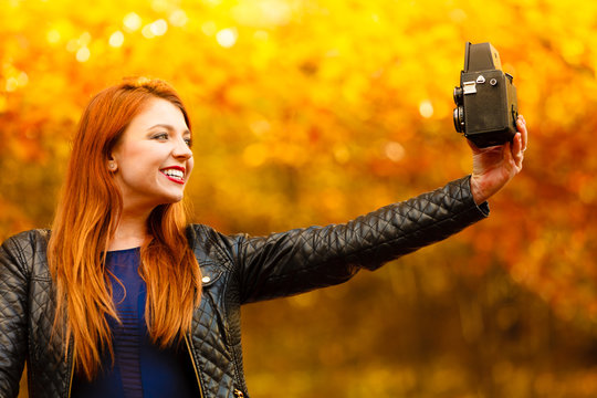woman taking photo picture with old camera outdoor