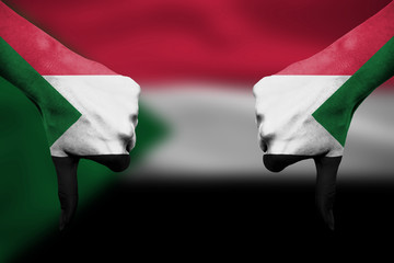 failure of Sudan - hands gesturing thumbs down in front of flag