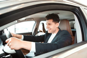 Handsome young man in dealership