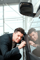 Handsome young man in dealership