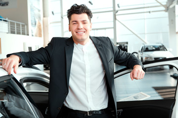 Handsome young man in dealership