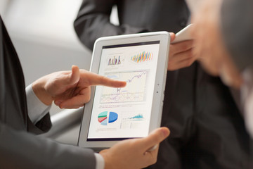 Hands of people working with tablet computer.