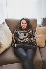Obraz premium Beautiful young brunette relaxing on a couch