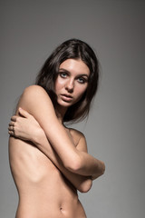Young sexy brunette fashion model, topless, glamour photo shoot