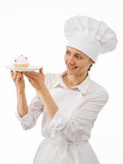 Beautiful woman chef cook showing a cake