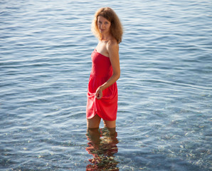 Smiling girl walking near the seashore