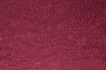 Texture of dark red wool fabric with multicolored shiny thread