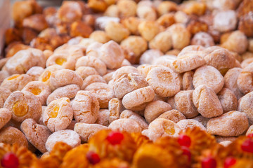 Various cakes and cookies on a counter of shop
