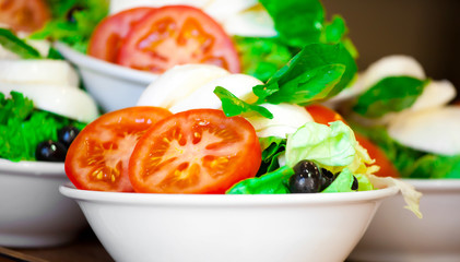Italian salad from cherry tomatoes, a mozzarella and lettuce in