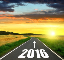 Asphalted road at sunset .Forward to the New Year 2016
