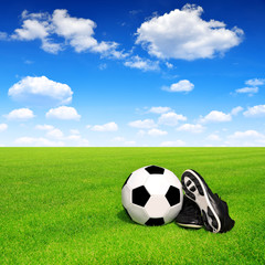 soccer ball and shoes in grass