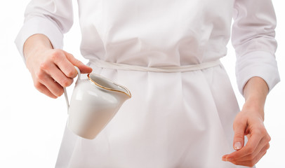 Fototapeta na wymiar Woman chef holding milk jug.