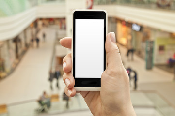 Fototapeta na wymiar Smartphone with empty screen in woman hand in shopping center