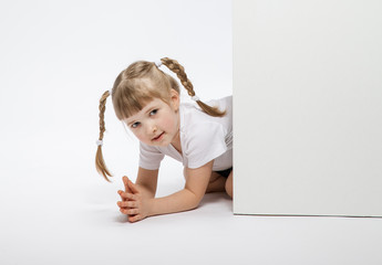 Pretty little girl looking  out of the door