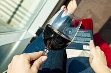 Relaxing with wine and book - POV photo