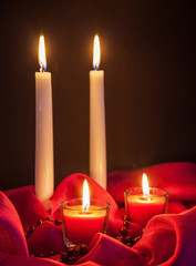 Beautiful candles on red cloth