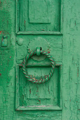 Old green door with a round handle