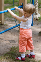 Active little child climbing on a ladder