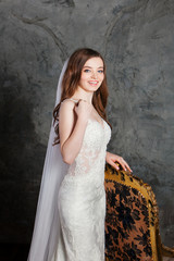 Fototapeta na wymiar Photo of a beautiful happy bride in luxurious wedding dress into