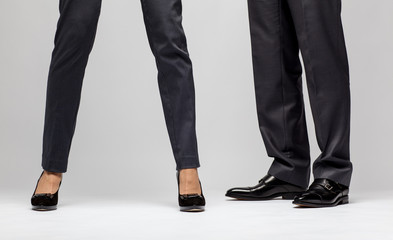 Male and female businessperson's legs - closeup shot