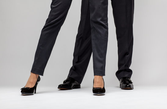 Male and female businessperson's legs