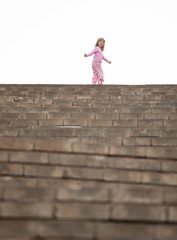 Little girl walking upstairs