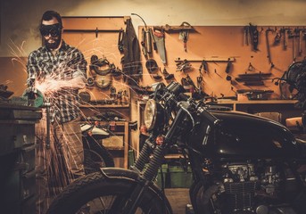 Mechanic doing lathe works in motorcycle customs garage
