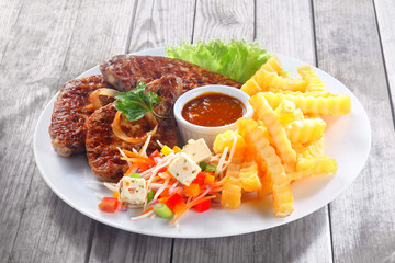 Fried Meat Slices with Potato Fries and Sauces