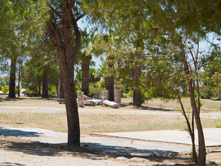 Obraz premium Ruins of the ancient temple columns under green trees