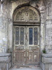 Fototapeta na wymiar Old weathered gray wooden vintage door with decoration