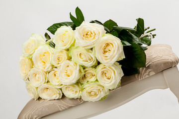 Bouquet of beautiful tea-roses on a banquette