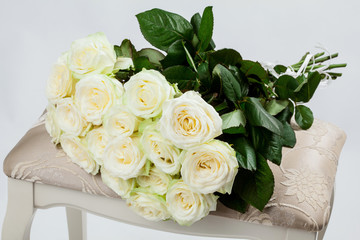 Bouquet of beautiful tea-roses on a banquette