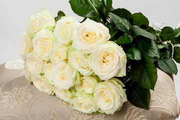 Bouquet of beautiful tea-roses on a banquette