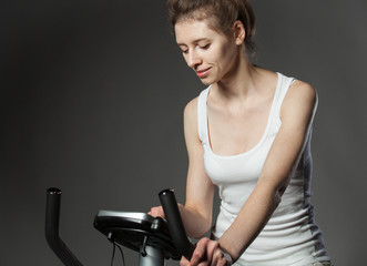 Fototapeta na wymiar Woman on a training bicycle