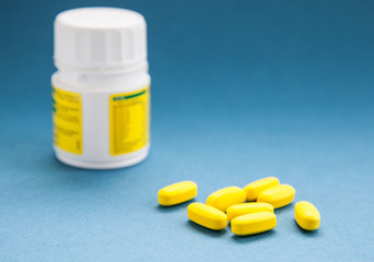 Yellow tablets and bottle