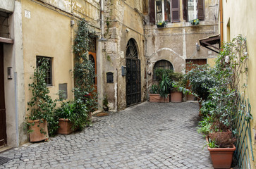 Fototapeta na wymiar ROME, ITALY – FEBRUARY 22, 2015: Charming old and small street