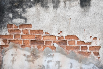 Cracked concrete showing brick wall inside