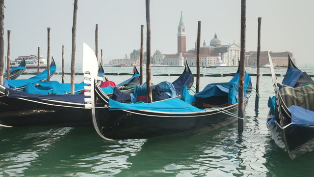 Venetian gondolas tied near the pier on San Marco
