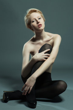 Elegant nude woman with short blond  hair.