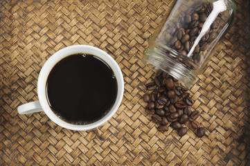 A cup of coffee and coffee bean