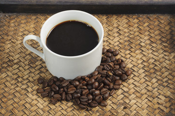 A cup of coffee and coffee bean