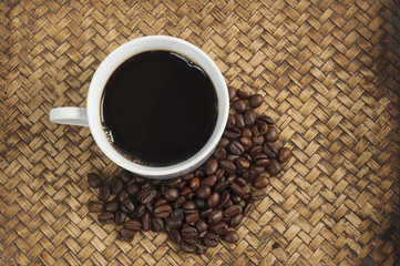 A cup of coffee and coffee bean