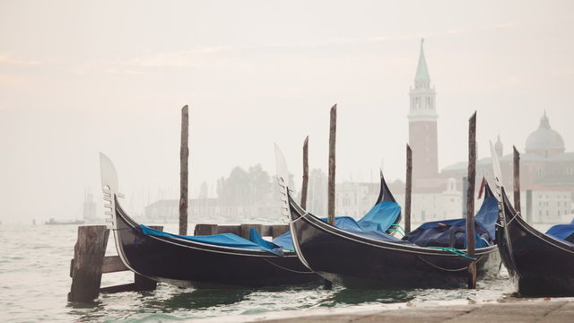Venetian gondolas tied near the pier on San Marco square
