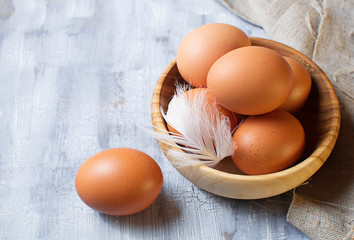 Brown eggs in a wooden bowl