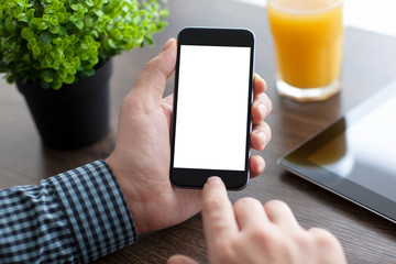 man holding a phone with isolated screen over the desk