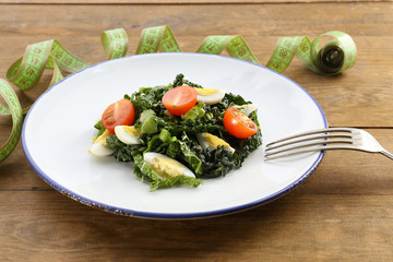 Salad with quail egg and basil in plate