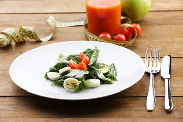 Salad with quail egg and basil in plate