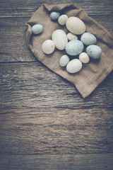 Easter Eggs on Rustic Wooden Background with Retro Instagram Sty
