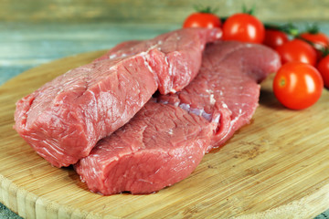 Raw beef steak with cherry tomatoes