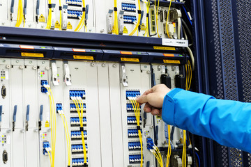 Man connecting network cables to switches